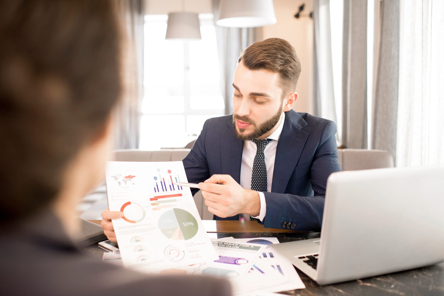 Advisor presenting a financial chart to clients